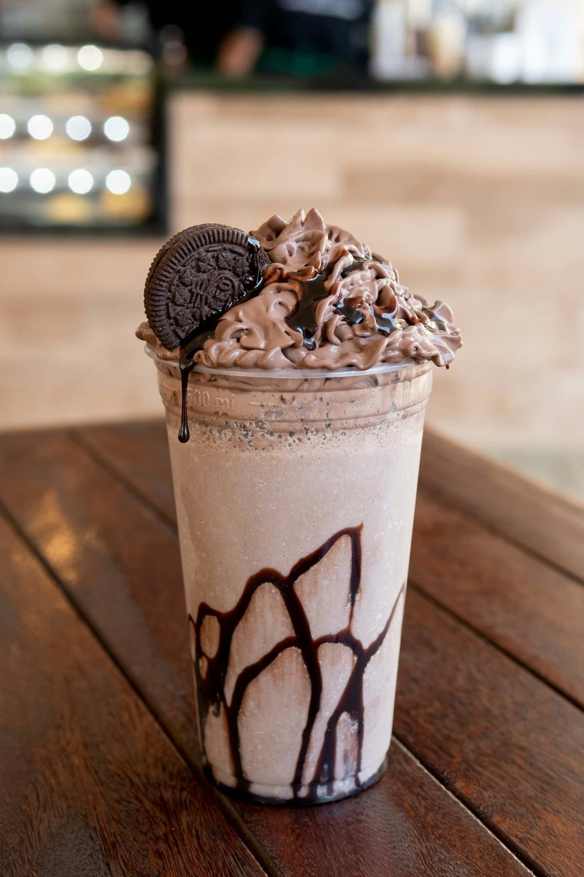 A specialty latte served alongside a slice of house-made cake